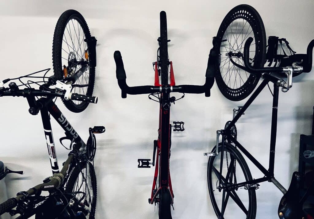 mountain bike, road bike and single speed hanging from the wall