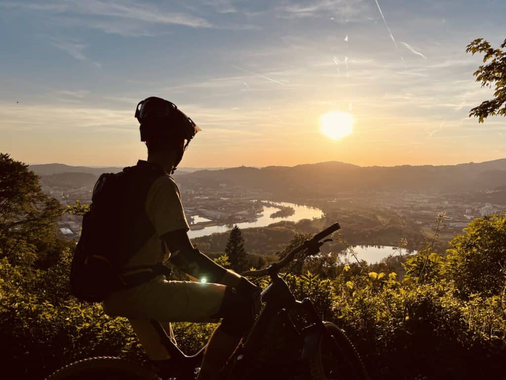 mountain biker looking into the sunset