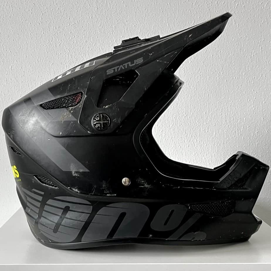 100% Status helmet in black with visor tilted up