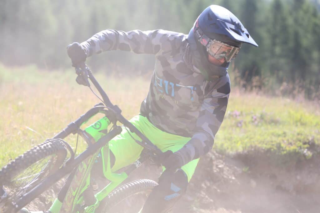 downhill biker leaning over in a berm