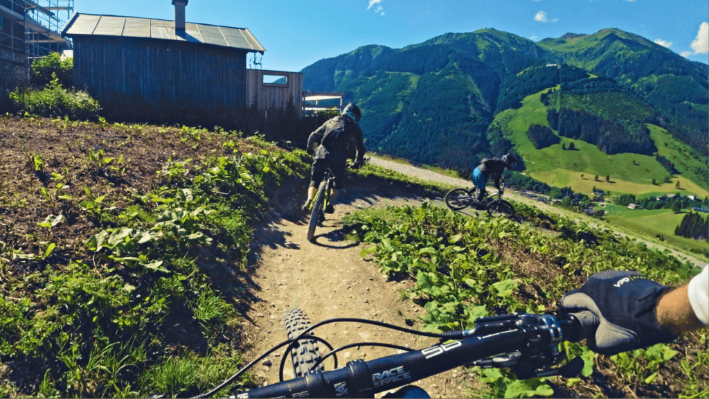 mountain bikers riding in a group down a trail